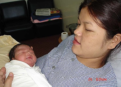His wife Mary with her new baby, little Kenneth.