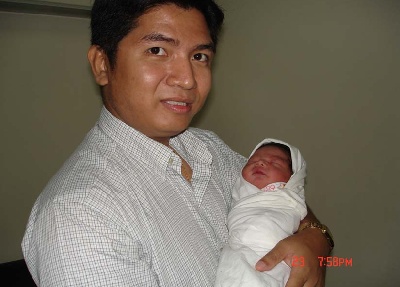 Pastor Martin with new baby Kenneth. Congratulations!